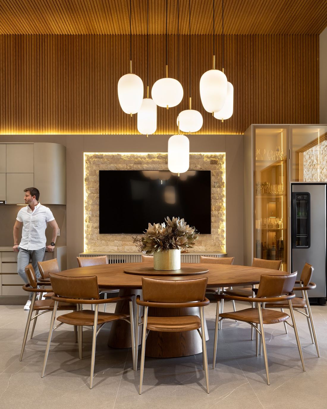 Área gourmet da Casa Dádiva, com painel em pedra e pendentes